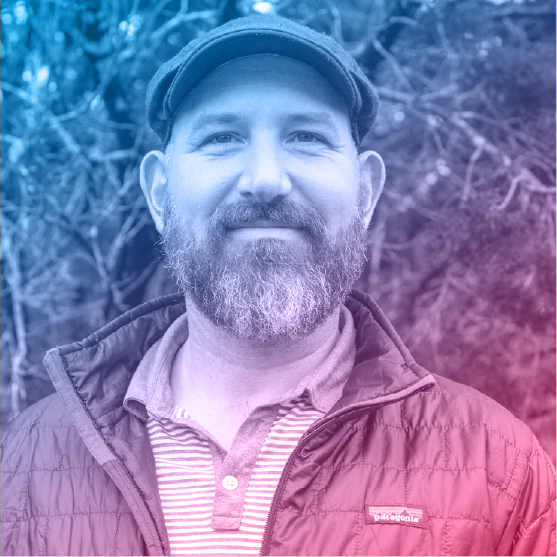 Portrait of Charles Lowell. He has a salt and pepper beard beard and a hat.