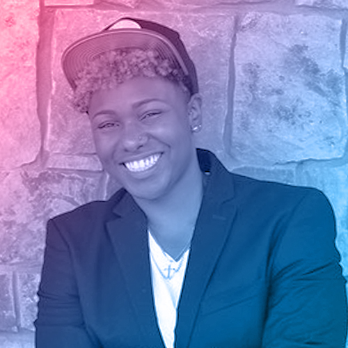 Portrait of Rachelle. She's wearing a hat and has curly hair.